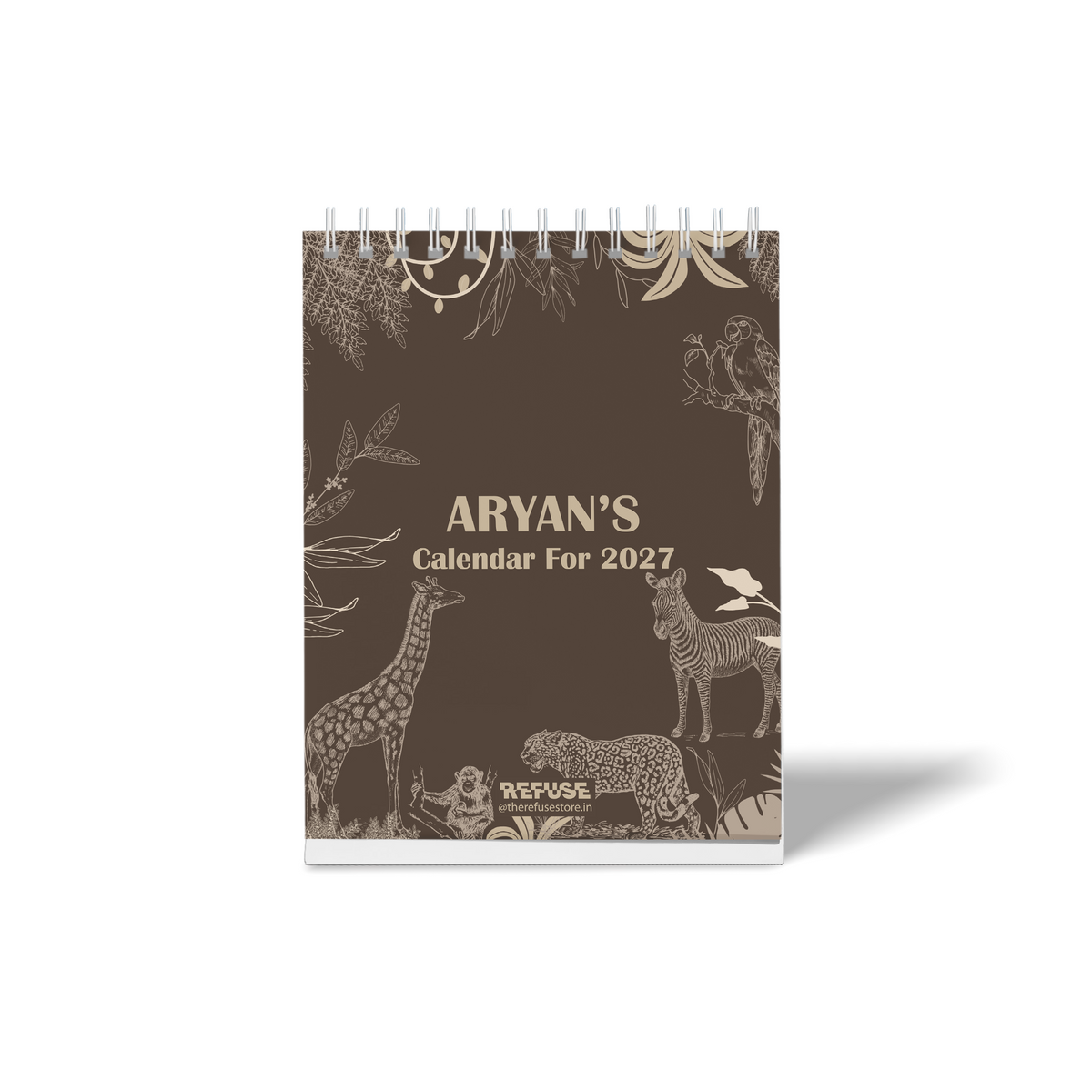 Personalised 2027 desk calendar cover with custom name” featuring a dark brown jungle theme with illustrated giraffe, zebra, leopard, monkey, parrot, and tropical foliage.