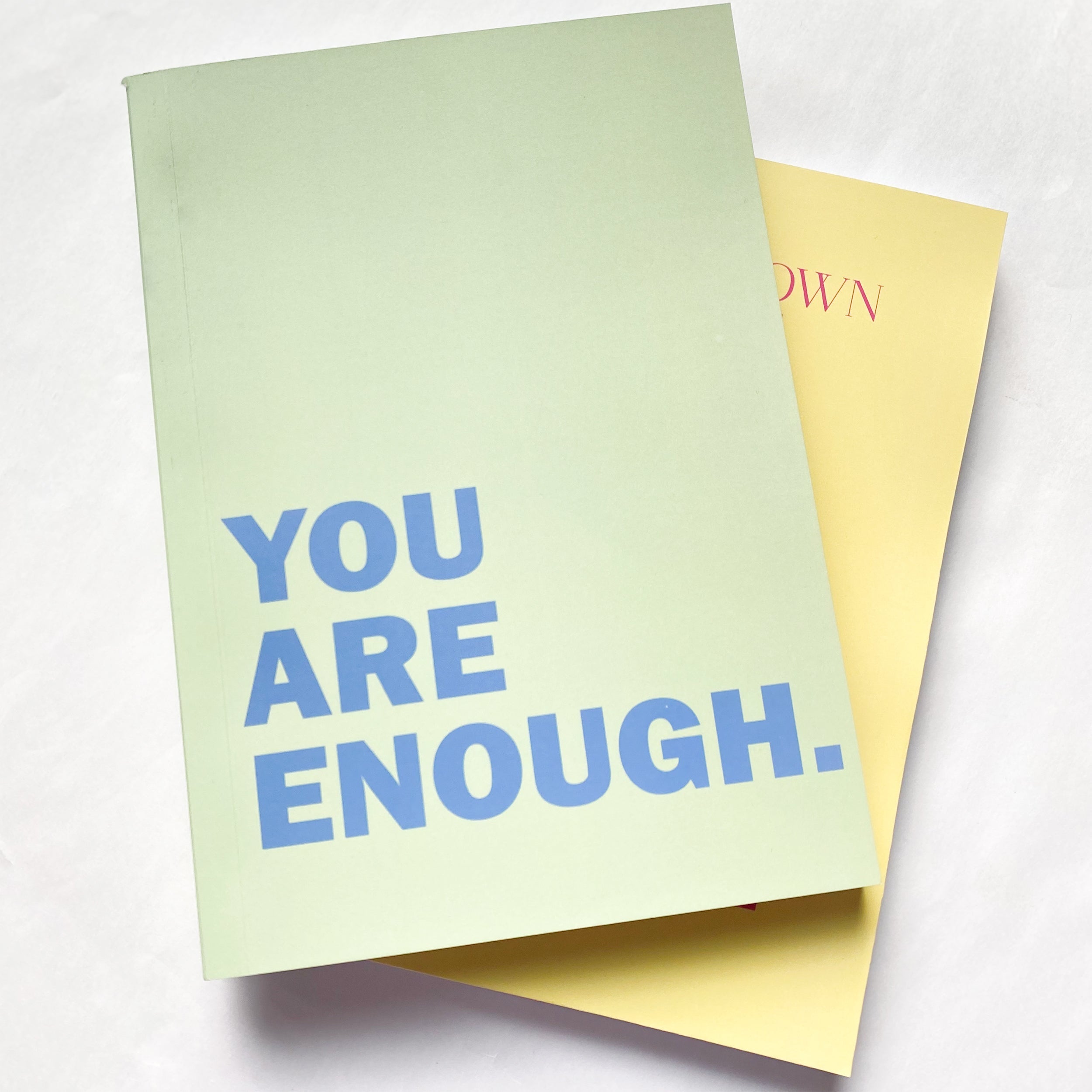Green Notebook with quote you are enough in blue