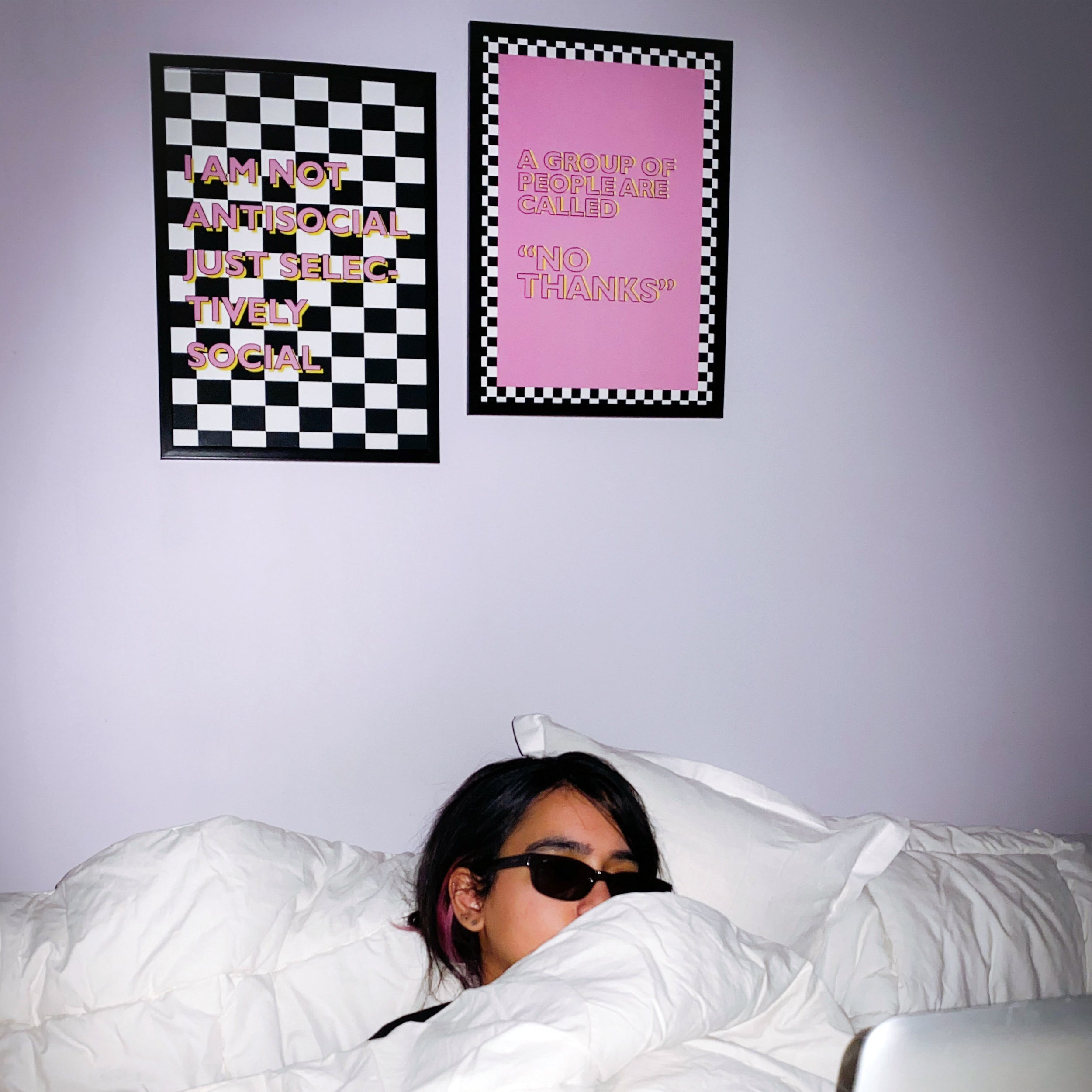 Antisocial themed posters hanging on a wall