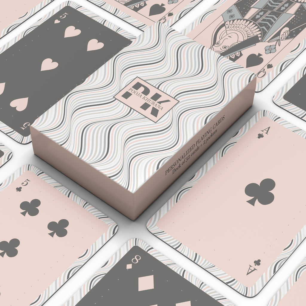 Personalised playing card set with a retro wavy pattern box and deck featuring peach and charcoal geometric playing card designs.