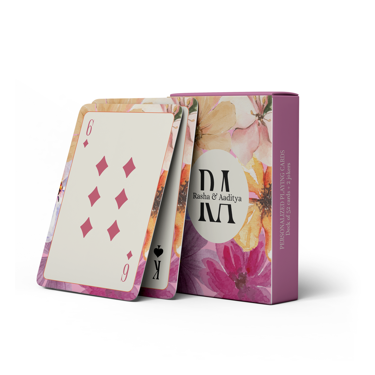 Personalised floral playing cards featuring a pink and purple watercolor flower design, with personalised initials and names on the matching card box.