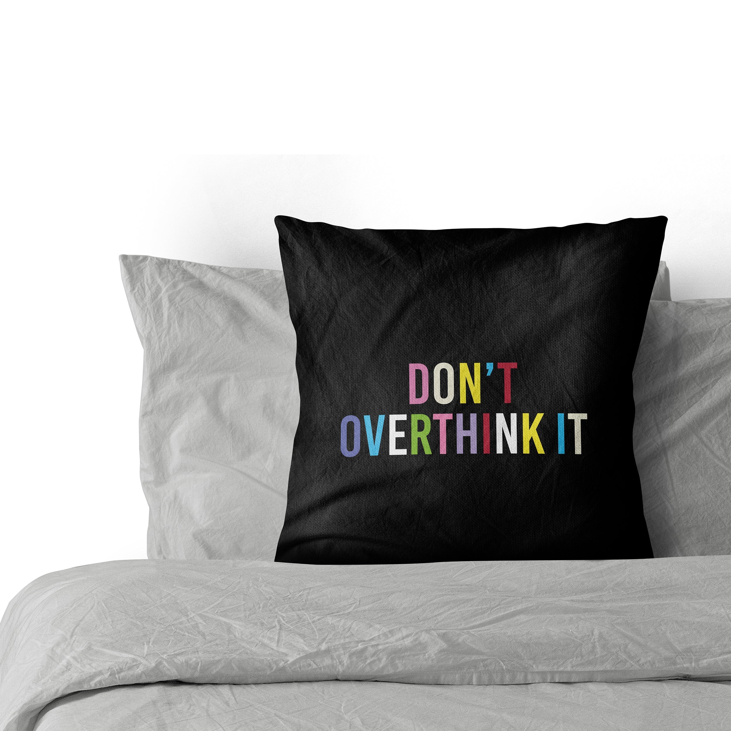 Don't Overthink It Cushion Cover on a bed