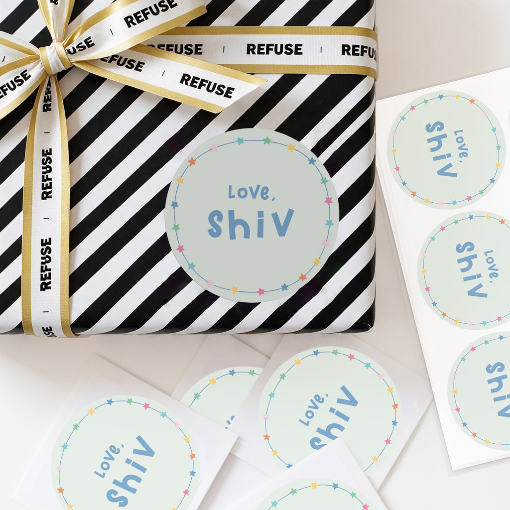 Personalised stary stickers displayed on a wrapped gift, with colourful abstract dots and custom name text.