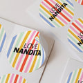 multi coloured striped personalised stickers with custom name text, shown arranged on a white background.