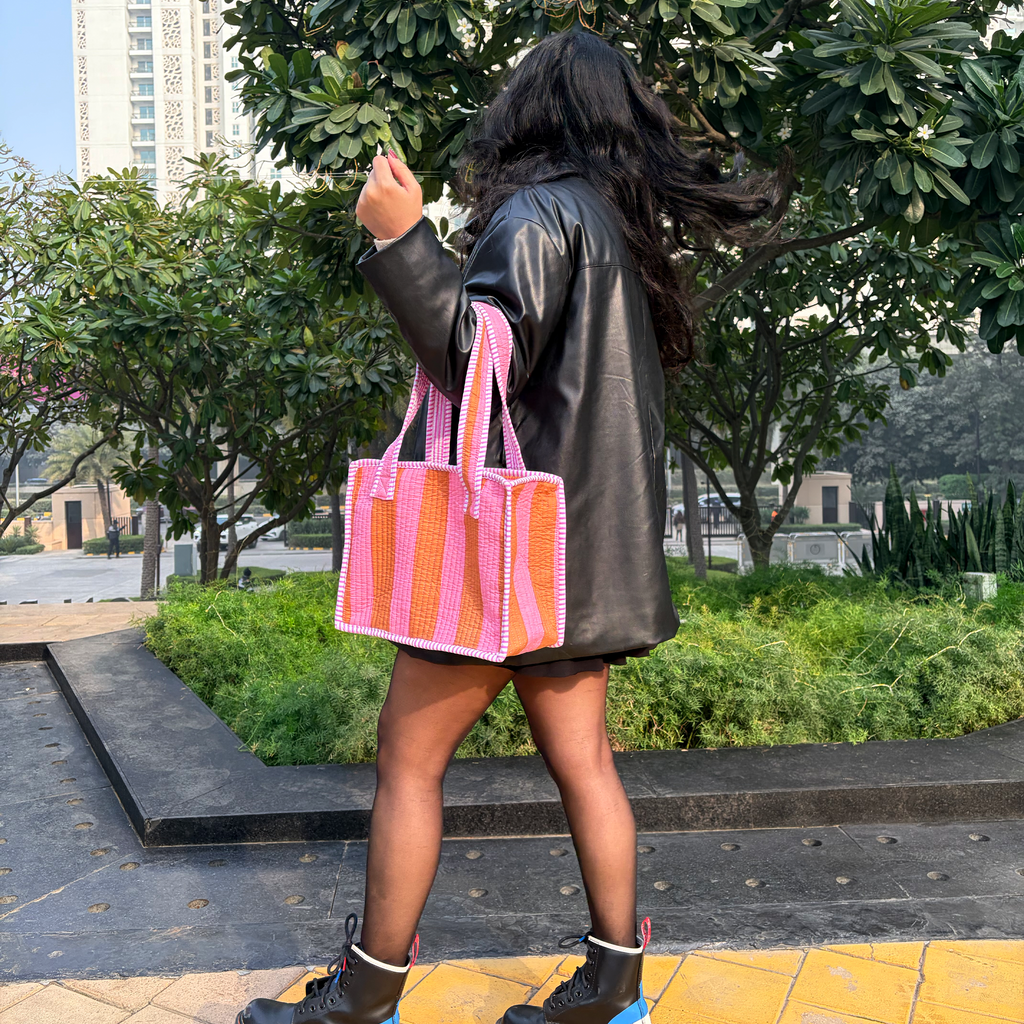Girl holding Pink & Rust Bold Striped Quilted Mini Tote Bag