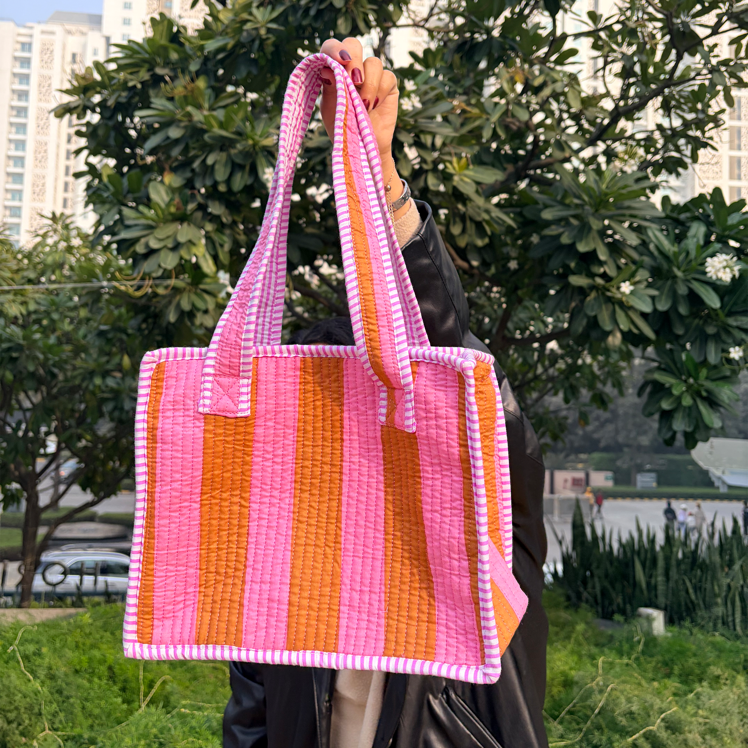 Girl holding Pink & Rust Bold Striped Quilted Mini Tote Bag